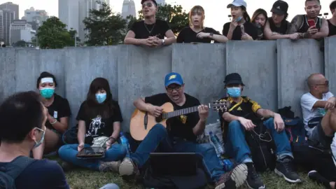 Getty Images Protesters gather near the Legislative Council Complex singing encouraging songs to support the movement