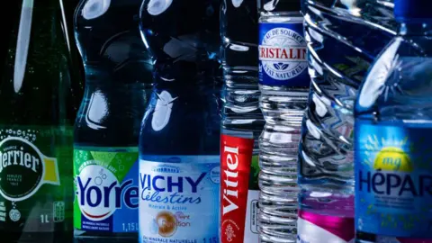 Getty Images Bottles of Perrier, Yorre, Vichy, Vittel, Cristaline, Contrex and Hepar water stand next to each other on a table