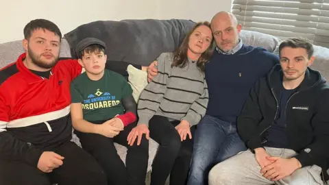 BBC Harry Parker's family sitting on a sofa