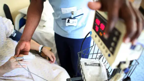 Getty Images A nurse looks after a patient