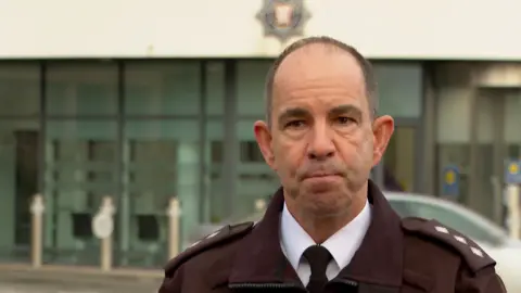 DCI Chris Beechey stands in front of the States of Jersey building