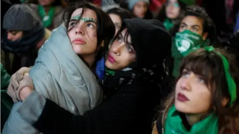 Reuters Two women hold each other as they wait for the vote result outside the Congress