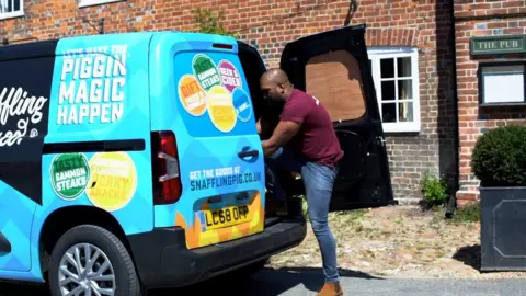 Snaffling Pig Driver delivering products from back of van