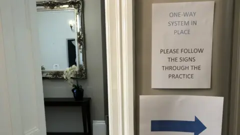 Dental practice with sign on door saying "one way system in place"