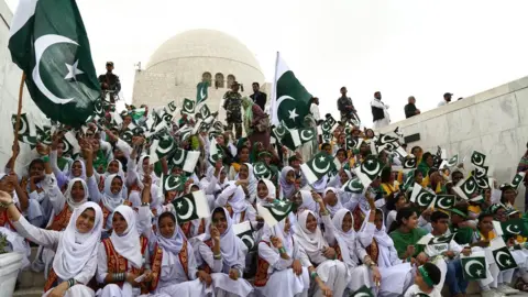 AFP Pakistani students hold national flags during a ceremony at the mausoleum of Pakistan's founder Mohammad Ali Jinnah to mark Independence Day in Karachi on 14 August 2017