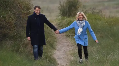 Getty Images Emmanuel and Brigitte Macron posing for photographs during the presidential campaign