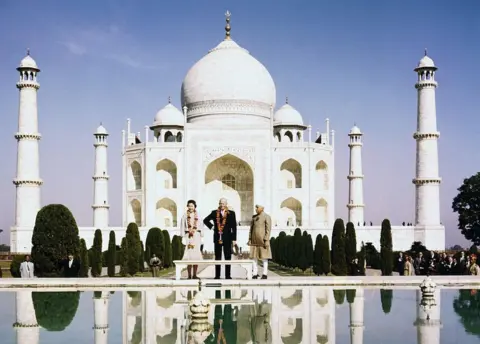 Getty Images President Eisenhower, daughter-in-law Barbara, and Indian Prime Minister Jawaharlal Nehru (right) stand before the famed Taj Mahal, their images reflected in the pond at their feet