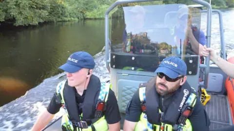 Police on a rigid inflatable boat on the River Ouse