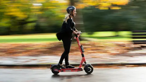 Voi Woman on an e-scooter