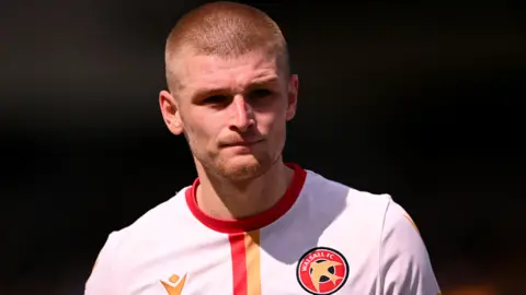 Ryan Stirk playing for Walsall wearing their away kit