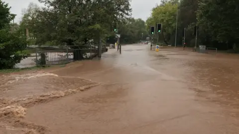 Floodwater around a set of traffic lights.