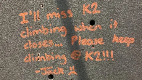 Simon Mutter A message written on a wall in chalk reads 'I'll miss K2 climbing when it closes. Please keep climbing @K2 - Jack. 