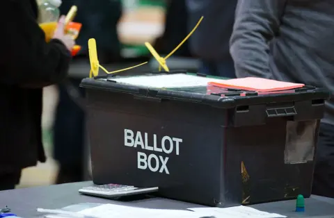PA Media A sealed black ballot box with white text reading "ballot box"