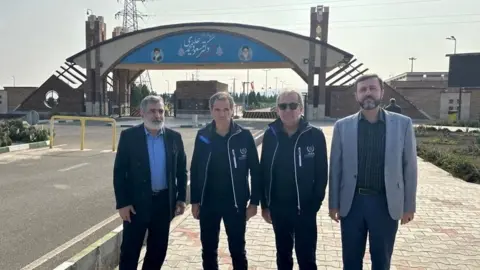 Reuters Handout Photo showing the director general of the AIEA, Rafael Grossi (2nd L) standing next to the deputy chief of the Iran's atomic energy organization, Behrouz Kamalvandi (L), in front of the Fordo nuclear installation near Qom, Iran (November 15, 2024)