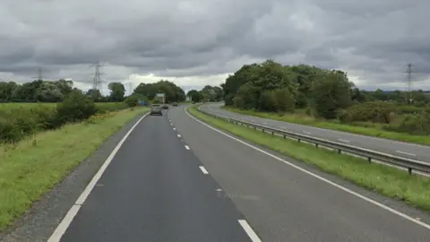 Google A dual carriageway, the A64, with some cars travelling on it.