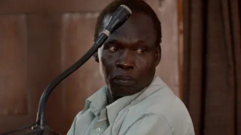 Getty Images Thomas Kwoyelo in court in Kampala in 2017