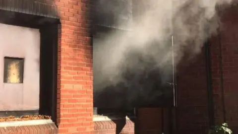 Jersey Fire and Rescue Service Smoke billowing out of a window at the service's training property.