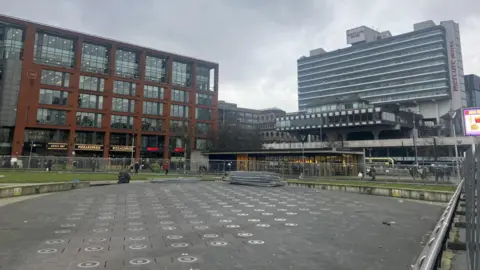 Piccadilly Gardens pictured in February, showing it an are with metal fences around it. 
