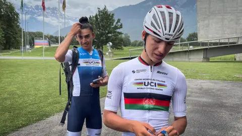 Yulduz and Fariba stand in front of the World Cycling Centre building