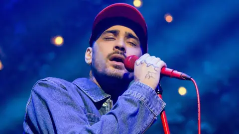 Getty Images Zayn Malik singing on stage