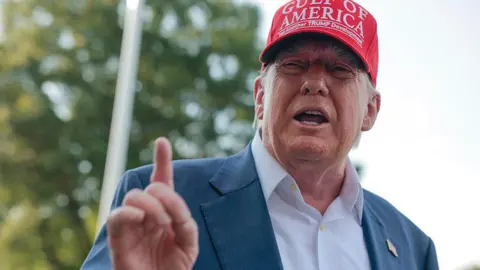 US President Donald Trump speaks to reporters on the South Lawn before boarding Marine One and departing the White House on 1 July, 2025 in Washington, DC.