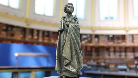 Ian Vogler/ Getty Images A model scale statue of Queen Elizabeth II.