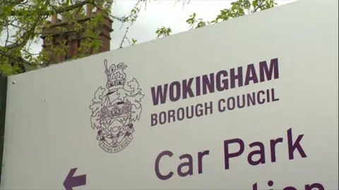 A white sign bears the words "Wokingham Borough Council" above the words "car park"