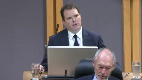 Senedd Cymru Lee Waters sat looking at the first minister in the Senedd on Tuesday