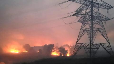 Wildfire burning near pylons