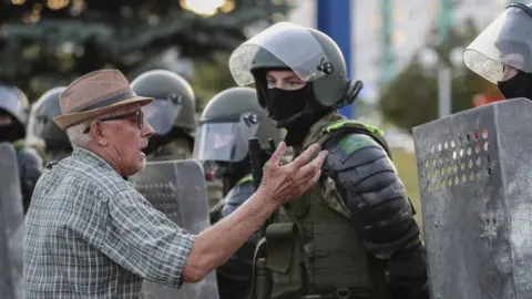 EPA A man speaks with Belarus military special forces during a protest after the presidential election, in Minsk, Belarus, 11 August 2020