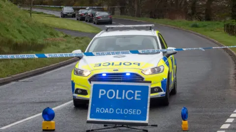 Pacemaker Police vehicles at the closed Ballyquin Road near Dungiven