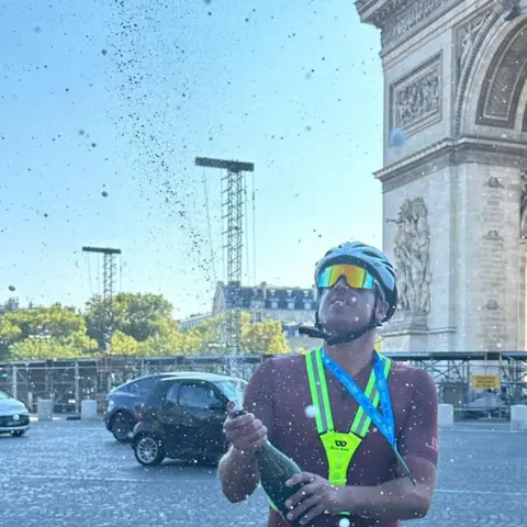 Victoria Hurst Cyclist spraying Champagne in Paris