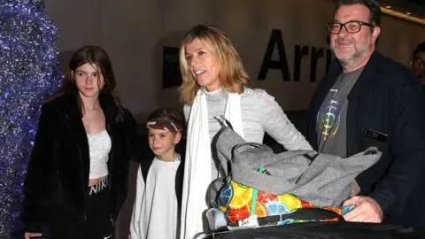 Getty Images Kate Garraway with her husband and children