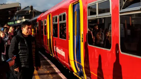 Getty Images Crowds wait for a South Western Railway service