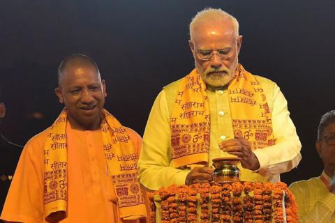 India's Prime Minister Narendra Modi (R) inaugurates 'Deepotsav' event as the chief minister of Uttar Pradesh state Yogi Adityanath watches on the eve of Diwali, the Hindu festival of lights, in Ayodhya on October 23, 2022.