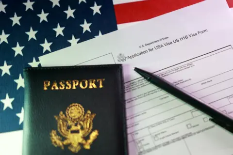 Walmart halts job offers for H-1B visa candidates Reuters An application for an H-1B visa sits on a table alongside a US passport, a pen and an American flag.