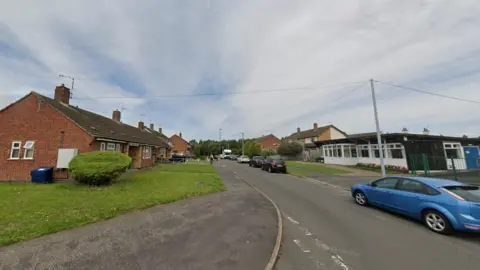 Biddle Street in Littlethorpe, Leicester, from the view of Bingley Road, showing a village hall building on the right and bungalows on the left 