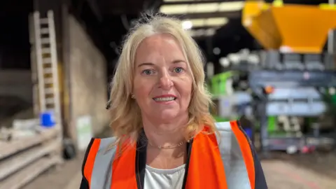Go4Greener Managing Director Samantha Turton is pictured in an orange hi viz vest
