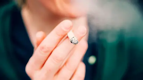 Getty Images A woman holding a cigarette