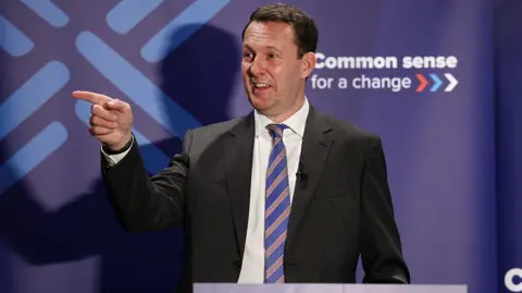 Getty Images Scottish Conservative Party leader Russell Findlay makes a keynote speech to members.