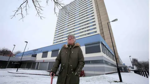 Newcastle Chronicle Woman outside tower block in Newcastle