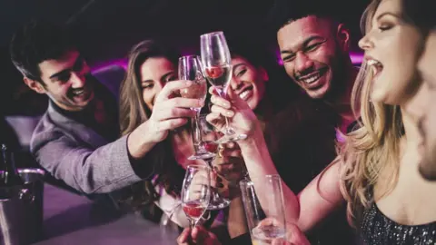 Getty Images Group of friends drinking stock image