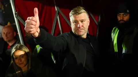 Salford City boss Karl Robinson gives a thumbs up by the tunnel after their play-off semi-final win over Grimsby Town