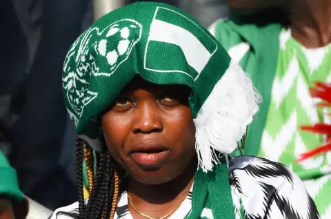 AFP A supporter looks on during the African Cup of Nations qualification match between Nigeria and Libya in Uyo, Akwa Ibom State in southern Nigeria, on October 13, 2018. - Nigeria beat Libya 4-0 with Odion Ighalo grabbing a hat-trick for the Super Eagles to get their 2019 Africa Cup of Nations qualifying campaign firmly back on track in Uyo, southern Nigeria