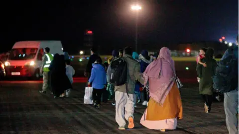 MOD/PA Media British nationals and Afghan evacuees arrive on an RAF plane at Brize Norton