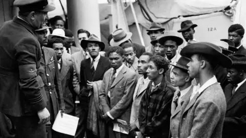 PA Windrush generation members arrive