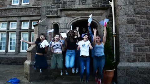 Jersey College for Girls Girls jumping outside JCG celebrating exam results