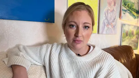 Robby West/BBC Elizabeth Murray on her sofa