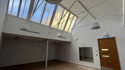 LDRS An empty white studio with sky lights