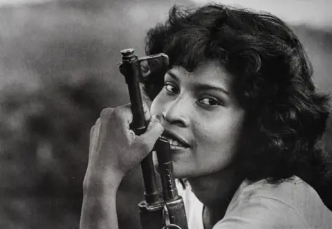 Javier Bauluz A picture of a medical student with a rifle in the 1980s